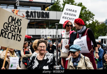 Berlin, Germany. 14th July, 2019. 'Grandma against the Right' is written on numerous signs by demonstrators protesting against a 'right-wing' demonstration on Breitscheidplatz. Credit: Paul Zinken/dpa/Alamy Live News Stock Photo