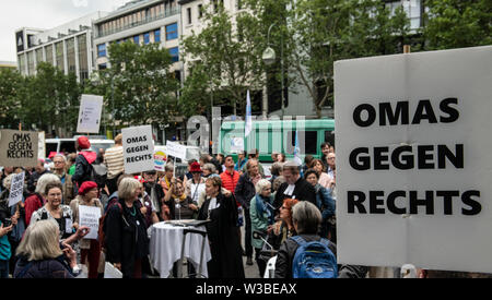 Berlin, Germany. 14th July, 2019. 'Grandma against the Right' is written on numerous signs by demonstrators protesting against a 'right-wing' demonstration on Breitscheidplatz. Credit: Paul Zinken/dpa/Alamy Live News Stock Photo