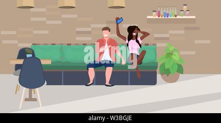 mix race couple sitting on couch man woman using smartphone spending time together people having fun modern cafe interior flat horizontal full length Stock Vector