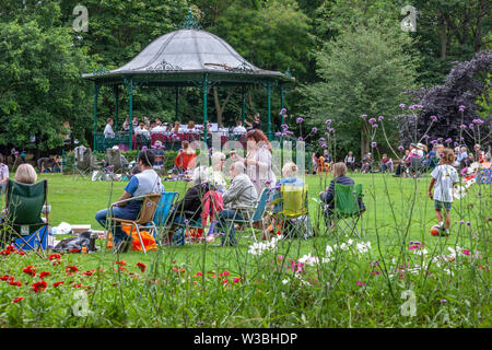 Northampton, UK. 14th July 2019. Light Clouds giving a warmish Sunday afternoon for people in Abington Park having a picknic and enjoy the Band in the Park, which is on every Sunday between 2 to 5 pm, a different band plays each week from April to September, the band today is Corby Steel Band. Credit: Keith J Smith./Alamy Live News. Stock Photo