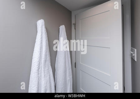 Two Towels Hanging In Simple Plain Bathroom Stock Photo