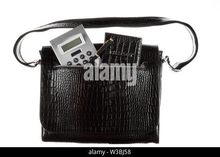 Calculator, pen and passport sticks out of a leather bag pocket. On a white background. Business portfolio Stock Photo