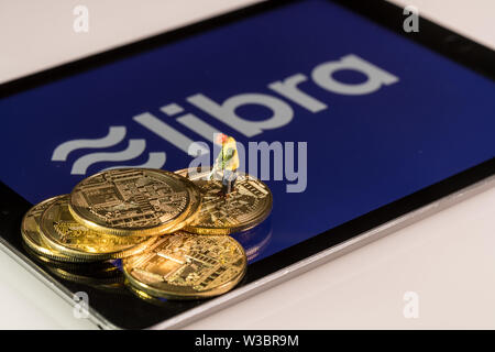 Golden coins on top of tablet computer for Libra cybercurrency Stock Photo