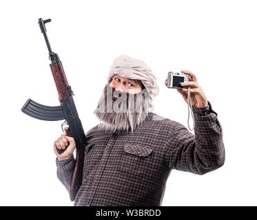 The bearded man with kalashnikov make selfie photo isolated on a white background. Funny warrior with automatic weapon smiling to camera. Stock Photo