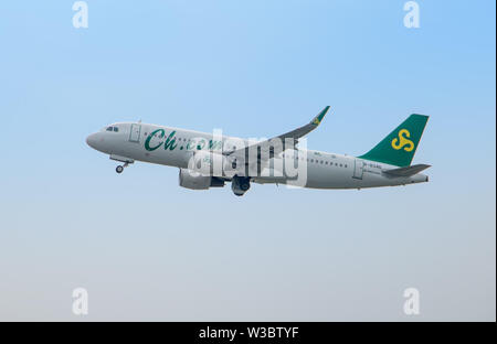 BANGKOK, THAILAND, JUN 03 2019, Spring Airlines plane flies in the blue sky. The Chinese plane takes off and pull-in the chassis. Stock Photo