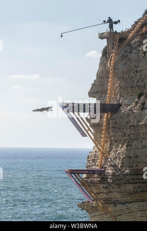 Beirut, Lebanon. 14th July 2019. Male and  female competitors jump off Raouche Rock also known as 'The Pigeon Rock' in the Red Bull Cliff Diving World Series Diving competition in Beirut Lebanon between twenty-four athletes 10 females and 14 males from 18 different nationalities will be diving from 21 to 27 meters high at a speed of 85km/h. Lebanon is the 5th stop in 7 competitions of The Red Bull Cliff Diving World Series.Credit: amer ghazzal/Alamy Live News Stock Photo