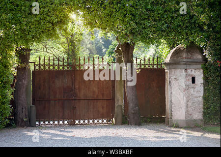 Marlia, Lucca, Italy - 2018, May 25: An old iron rusted gate is one of the access at Villa Reale in Marlia. Stock Photo
