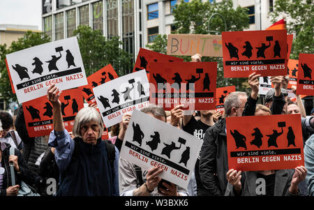 Berlin, Germany. 14th July, 2019. 'Berlin against Nazis' is written on numerous signs of demonstrators protesting against an extreme right-wing rally on Breitscheidplatz. Credit: Paul Zinken/dpa/Alamy Live News Stock Photo