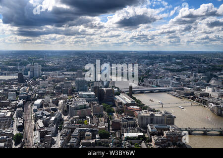 Aerial view of South London England with London Eye, train tracks The Vase and bridges over the muddy River Thames