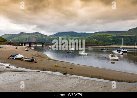 The historic railway bridge across the Mawddach estuary viewed from the harbour in Barmouth, Gwynedd, Wales, UK Stock Photo