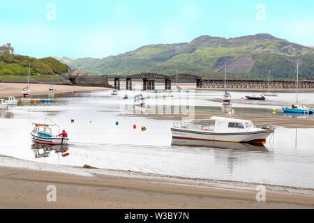 The historic railway bridge across the Mawddach estuary viewed from the harbour in Barmouth, Gwynedd, Wales, UK Stock Photo