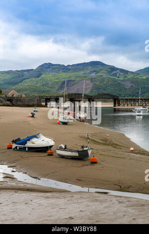 The historic railway bridge across the Mawddach estuary viewed from the harbour in Barmouth, Gwynedd, Wales, UK Stock Photo