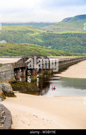 The historic railway bridge across the Mawddach estuary viewed from the harbour in Barmouth, Gwynedd, Wales, UK Stock Photo