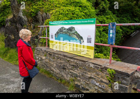 Information board about the historic railway bridge across the Mawddach estuary viewed from the harbour in Barmouth, Gwynedd, Wales, UK Stock Photo