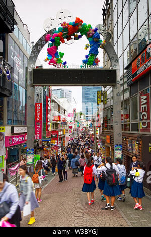 Young people walk down Takeshita-dori, in the Harajuku district of Tokyo, Japan looking for teen fashion and other bargains Stock Photo