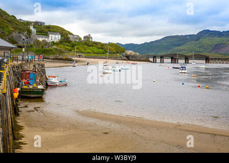 The historic railway bridge across the Mawddach estuary viewed from the harbour in Barmouth, Gwynedd, Wales, UK Stock Photo