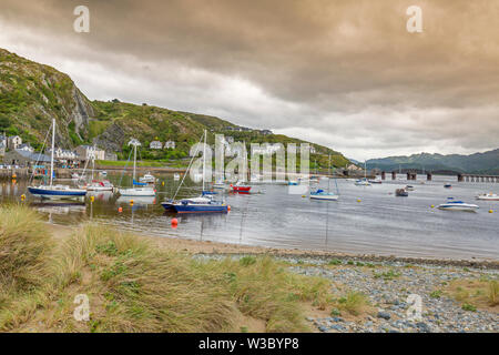 The historic railway bridge across the Mawddach estuary viewed from the harbour in Barmouth, Gwynedd, Wales, UK Stock Photo