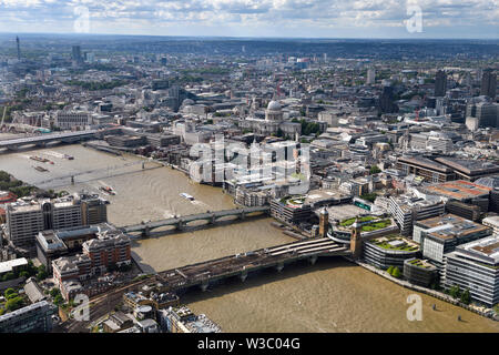 Aerial view of London England with BT Tower and bridges over the muddy River Thames and St Paul's Cathedral Anglican church Stock Photo