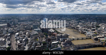 Aerial panorama of South London England with London Eye, train tracks The Vase and bridges over the muddy River Thames and St Paul's Cathedral Stock Photo