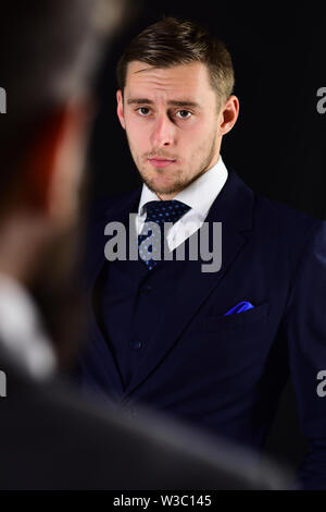 Businessmen look at each other with judgment. Eye contact concept. Businessmen, business partners meeting on black background. Business partners on se Stock Photo