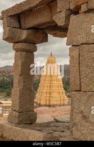 Virupaksha hindu temple gopuram through the Mandapa and ruins, Hampi, India Stock Photo