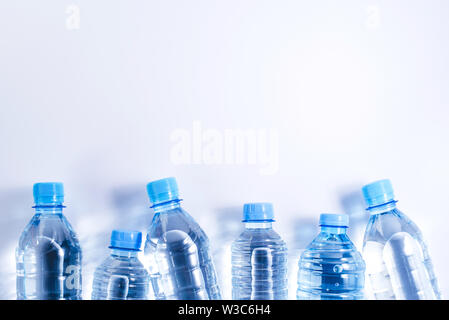 Several plastic water bottles on white background Stock Photo