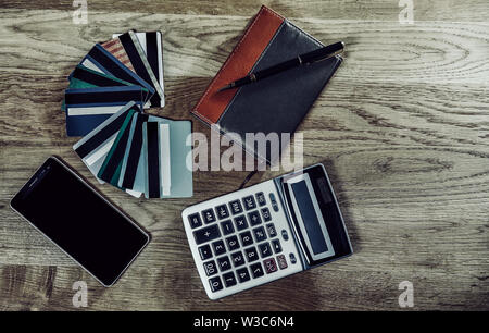 calculator, pen, notebook and bank discount and credit cards on a wooden background Stock Photo
