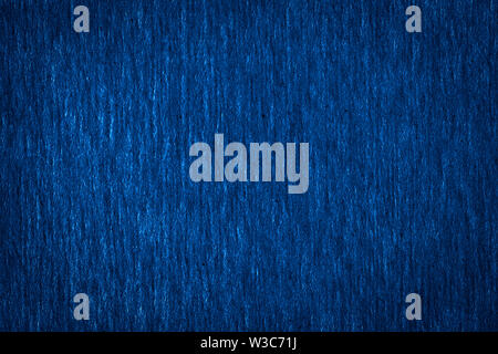 Abstract texture of a rough dark blue paper background and copy space for text. Macro fiber paper. Stock Photo