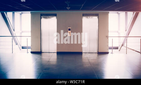 Glass wall with two elevators in the office building, there an empty space for your text Stock Photo