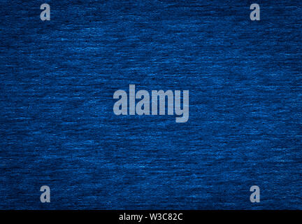 Abstract texture of a rough dark blue paper background and copy space for text. Macro fiber paper. Stock Photo