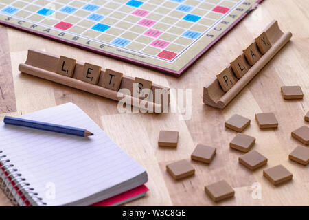 Scrabble board game with the scrabble tile spell 'Lets Play' Stock Photo