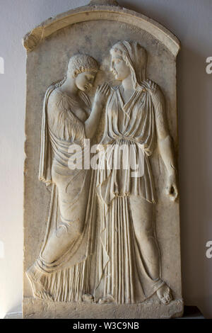 Rhodes Old City, Greece - September 26, 2018.   Gravestone stele of Krito and Timarista, mother and her daughter standing and embracing (4th century B Stock Photo