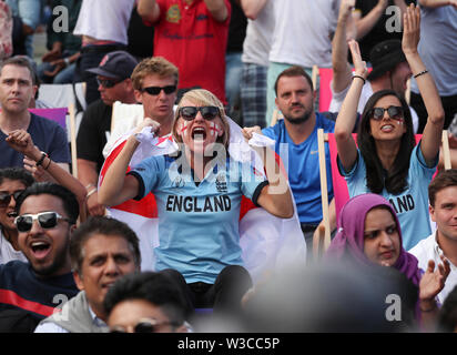 England and New Zealand fans react as they watch a big screen in the Fanzone at Trafalgar Square during the Cricket World Cup Final between New Zealand and England at the ICC Fanzone, London. Stock Photo