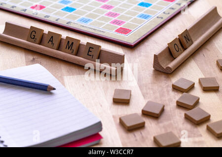 Scrabble board game with the scrabble tile spell 'Game On' Stock Photo