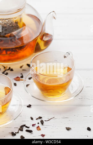 Herbal and fruit tea, teapot and cups on wooden table. With copy space Stock Photo
