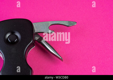 Tools with knife and opener and much more on pink Stock Photo