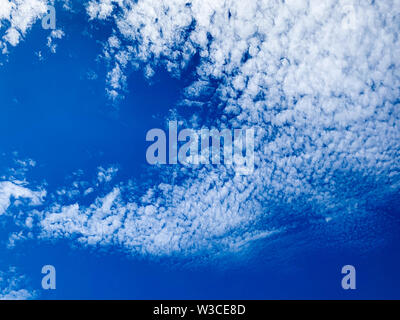 Cirrocumulus clouds are small rounded puffs that usually appear in long rows high in the sky. Cirrocumulus are usually white Stock Photo