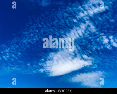 Cirrocumulus clouds are small rounded puffs that usually appear in long rows high in the sky. Cirrocumulus are usually white Stock Photo
