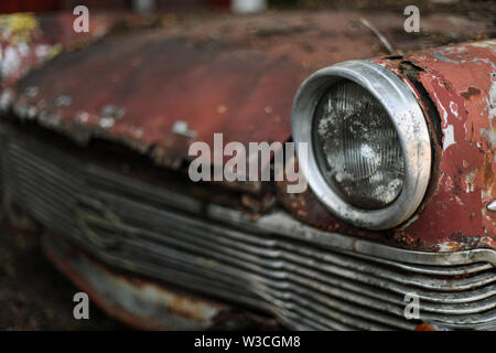 Old Opel headlamp at car junkyard in Ylöjärvi, rural Finland Stock Photo