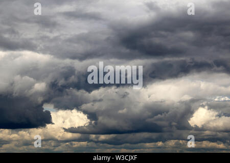 Storm sky covered with dark cumulus clouds before the rain. Dark cloudy sky, overcast day, beautiful dramatic background for rainy weather Stock Photo