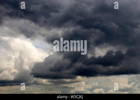 Storm sky covered with dark cumulus clouds before the rain. Dark cloudy sky, overcast day, beautiful dramatic background for rainy weather Stock Photo