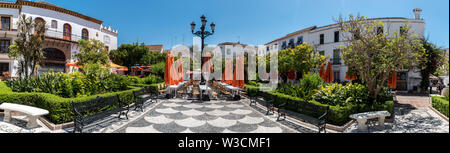 Plaza de los Naranjos (Plaza of the Oranges) located in Marbella with restaurants, shops and a fountain surrounded by orange trees. Stock Photo