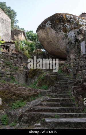 Stone cut historical houses built in between massive boulders in the village of Monsanto, Portugal. Stock Photo
