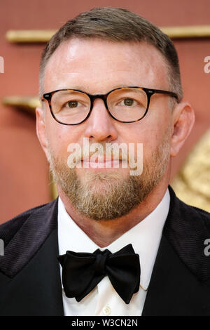 London, UK. 14th July 2019. Guy Ritchie poses on the yellow carpet at the European premiere of Disneys 'The Lion King' on Sunday 14 July 2019 at ODEON LUXE Leicester Square, London. . Picture by Julie Edwards. Credit: Julie Edwards/Alamy Live News Stock Photo