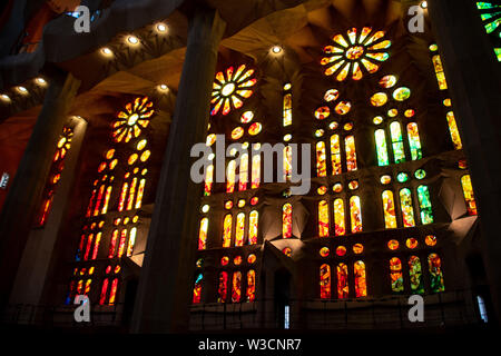 The stained glass rose windows from the interior of the Sagrada Familia in Barcelona, Spain Stock Photo