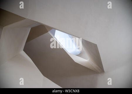 Staring up a spiral concrete staircase Stock Photo