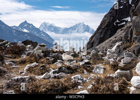 Traditional towers of stones near Gokyo lakes in Nepal Himalayas with snow covered peaks in background Stock Photo