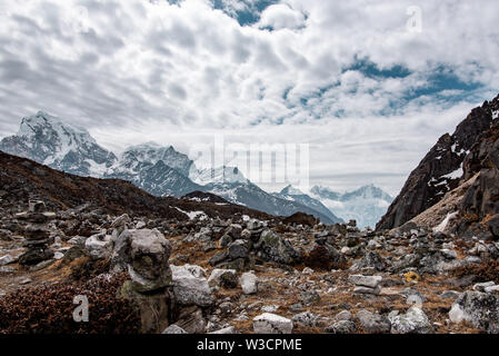 Himalayan scenery in Nepal near Gokyo, with textured cloudy sky and high snow covered peaks close by Stock Photo