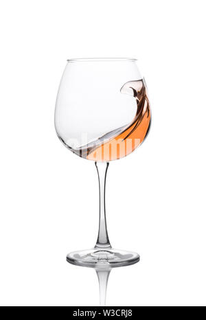 Glass of amber wine with splashes isolated on white. Stock Photo