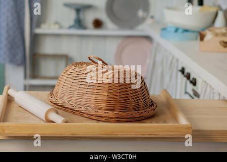 Wicker breadbasket on kitchen table at the photo studio. Stock Photo